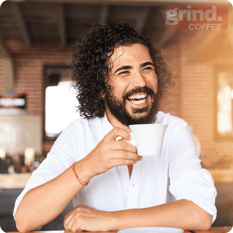 Bakery owner serving a customer whose phone shows a Loyaltymaster card being added to Apple Wallet