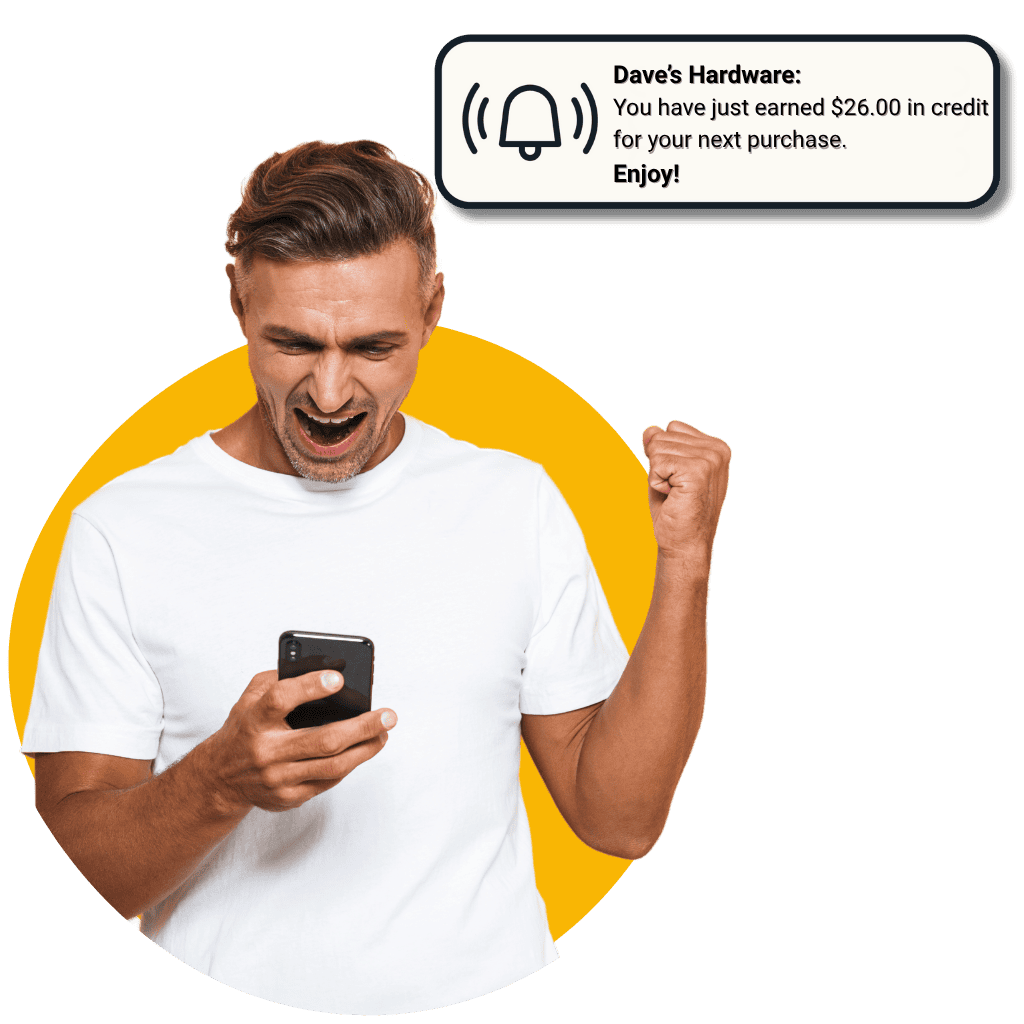 A man in a white t shirt smiles excitedly at his phone raising his fist in celebration A notification reads Daves Hardware You have just earned 00 in credit for your next purchase Enjoy